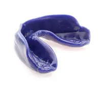 A blue mouthguard is shown on top of the floor.